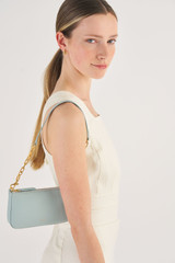 Profile view of model wearing the Oroton Eve Small Baguette in Duck Egg and Pebble leather for Women