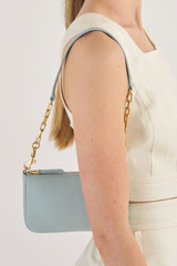Profile view of model wearing the Oroton Eve Small Baguette in Duck Egg and Pebble leather for Women