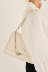 Profile view of model wearing the Oroton Elina Satchel in Milk and Pebble Leather for Women