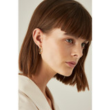 Profile view of model wearing the Oroton Bamboo Small Oval Hoops in Gold and Brass Base With 18CT Gold Plating for Women