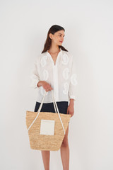 Profile view of model wearing the Oroton Jensen XL Tote in Nat/Paper White and Smooth Leather and Crocheted Straw for Women