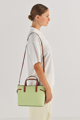 Profile view of model wearing the Oroton Harriet Mini Tote in Pear and Saffiano Leather With Smooth Leather Trim for Women