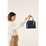 Profile view of model wearing the Oroton Harriet Mini Tote in Indigo and Saffiano Leather With Smooth Leather Trim for Women