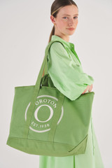 Profile view of model wearing the Oroton Kane Large Shopper Tote in Watercress and Recycled Canvas for Women