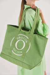 Profile view of model wearing the Oroton Kane Large Shopper Tote in Watercress and Recycled Canvas for Women
