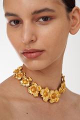 Profile view of model wearing the Oroton Aster Necklace in Worn Gold and Zinc Base With 18CT Gold Plating for Women