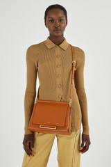 Profile view of model wearing the Oroton Elm Medium Day Bag in Brandy and Pebble leather with smooth leather trims for Women