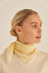 Profile view of model wearing the Oroton Elsie Scarf in Maize and 69% Cotton, 31% Silk for Women