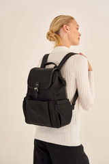Profile view of model wearing the Oroton Elsie Nylon Backpack And Mat in Black and Nylon And Pebble Leather for Women