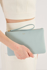 Profile view of model wearing the Oroton Eve Medium Pouch in Duck Egg and Pebble leather for Women
