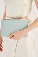 Profile view of model wearing the Oroton Eve Medium Pouch in Duck Egg and Pebble leather for Women