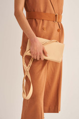 Profile view of model wearing the Oroton Jade Crossbody in Mango and Smooth Leather for Women