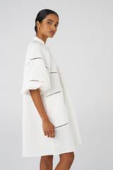 Profile view of model wearing the Oroton Ladder Stitch Smock Dress in White and 100% Linen for Women