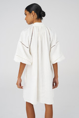 Profile view of model wearing the Oroton Ladder Stitch Smock Dress in White and 100% Linen for Women