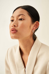 Profile view of model wearing the Oroton Fiona Small Oblong Hoops in Silver and Brass Base With Rhodium Plating for Women