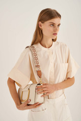 Profile view of model wearing the Oroton Logo Bag Strap in Cognac/Ecru and Smooth Leather And Webbing for Women