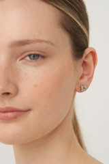 Profile view of model wearing the Oroton Kori Studs in Gold/Clear and  for Women