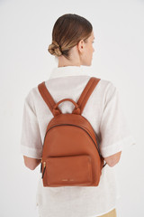 Profile view of model wearing the Oroton Lilly Small Backpack in Cognac and Pebble leather/Nylon for Women