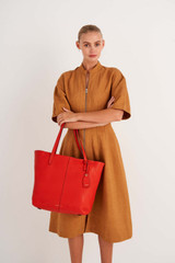 Profile view of model wearing the Oroton Lilly Shopper Tote in Crimson and Pebble Leather for Women