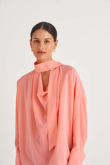 Profile view of model wearing the Oroton Fluid Blouse in Sherbet and 92% Silk 8% Spandex for Women