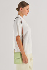 Profile view of model wearing the Oroton Harriet Phone Crossbody in Pear and Saffiano Leather for Women
