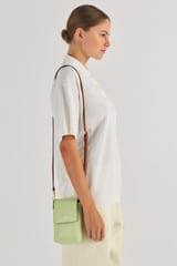 Profile view of model wearing the Oroton Harriet Phone Crossbody in Pear and Saffiano Leather for Women
