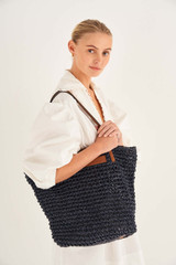 Profile view of model wearing the Oroton Lilly Crochet Medium Tote in Denim Blue and Paper Straw and Smooth Leather Trim for Women