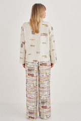 Profile view of model wearing the Oroton Long Sleeve Spaced Label Print Camp Shirt in Soft Cream and 100% Silk for Women
