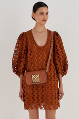Profile view of model wearing the Oroton Lane Crossbody in Brandy and Smooth Recycled Leather for Women