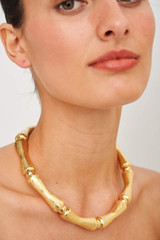 Profile view of model wearing the Oroton Bamboo Necklace in Gold and  for Women