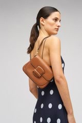 Profile view of model wearing the Oroton Carter Small Day Bag in Brandy and Smooth leather for Women