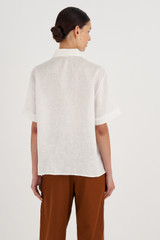 Profile view of model wearing the Oroton Bow Detail Shirt in Antique White and 100% Linen for Women