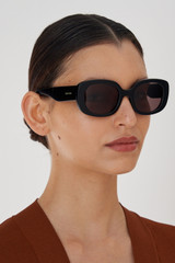 Profile view of model wearing the Oroton Haylen Sunglasses in Black and Acetate for Women