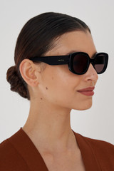 Profile view of model wearing the Oroton Haylen Sunglasses in Black and Acetate for Women