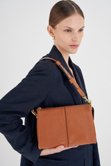 Profile view of model wearing the Oroton Emma Small Day Bag in Cognac and Pebble Leather for Women