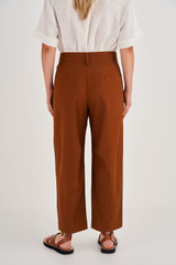 Profile view of model wearing the Oroton Curved Leg Pant in Tan and 100% Cotton for Women