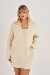 Profile view of model wearing the Oroton Double Breasted Knit Blazer in Vanilla Bean and 100% Cotton for Women