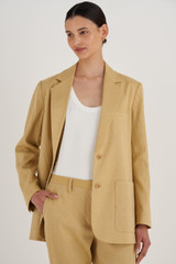 Profile view of model wearing the Oroton Blazer in Raffia and 81% Viscose, 17% Cotton, 2% Elastane for Women