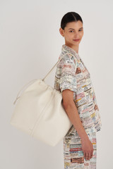Profile view of model wearing the Oroton Curtis XL Tote in Clotted Cream and Recycled Smooth Leather for Women