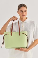 Profile view of model wearing the Oroton Harriet Medium Tote in Pear and Saffiano Leather With Smooth Leather Trim for Women