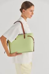 Profile view of model wearing the Oroton Harriet Medium Tote in Pear and Saffiano Leather With Smooth Leather Trim for Women