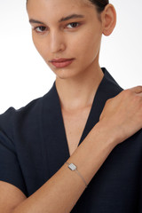 Profile view of model wearing the Oroton Fawne Rectangle Bracelet in Silver/Clear and Brass Base With Sterling Silver plating/Cubic Zirconia for Women