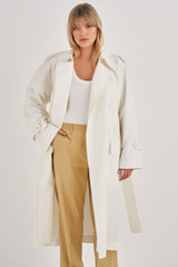Profile view of model wearing the Oroton Coated Trench in White and 42% Linen, 34% Cotton, 24% Polyurethane for Women