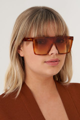 Profile view of model wearing the Oroton Carson Sunglasses in Amber Tort and Acetate for Women