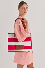 Profile view of model wearing the Oroton Daisy Large Tote in Apple/Cream and Stripe Canvas Fabric and Smooth Leather Trim for Women