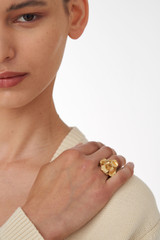 Profile view of model wearing the Oroton Aster Ring in Worn Gold and Brass Base With 18CT Gold Plating for Women