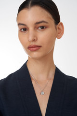 Profile view of model wearing the Oroton Fawne Circle Necklace in Silver/Clear and Brass Base With Sterling Silver plating/Cubic Zirconia for Women