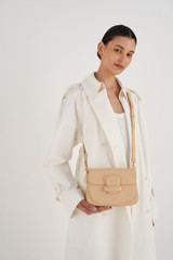 Profile view of model wearing the Oroton Carter Small Day Bag in Creamed Honey and Smooth Leather for Women