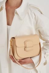 Profile view of model wearing the Oroton Carter Small Day Bag in Creamed Honey and Smooth Leather for Women