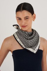 Profile view of model wearing the Oroton All Over Logo Silk Scarf in Cream/Black and 100% Silk for Women